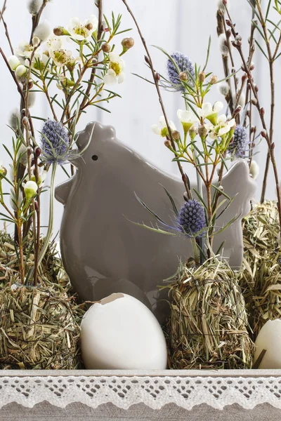 stock image Ceramic hen among twigs and flowers, easter decoration