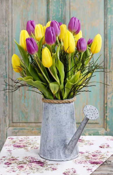 Bouquet of yellow and violet tulips in silver watering can — Stock Photo, Image