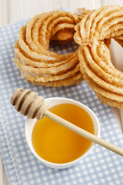 Churro donuts and bowl of honey — Stock Photo, Image