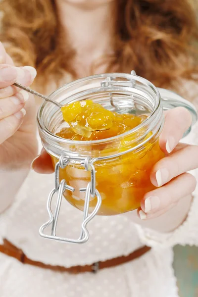 Woman holding jar of jam — Stock Photo, Image