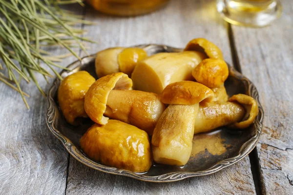 Pickled mushrooms on wooden table — Stock Photo, Image