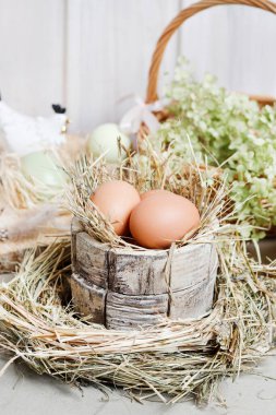 Seramik tavuk heykelcikleri, yumurtalar ve yeşil çiçeklerle şirin Paskalya süsleri. Kutlama zamanı.