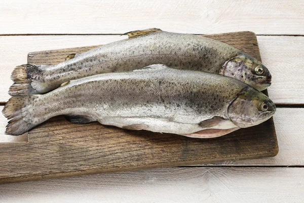 Two rainbow trouts on rustic wooden table — Stock Photo, Image