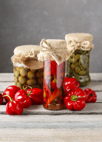 Pickled red peppers and olives — Stock Photo, Image