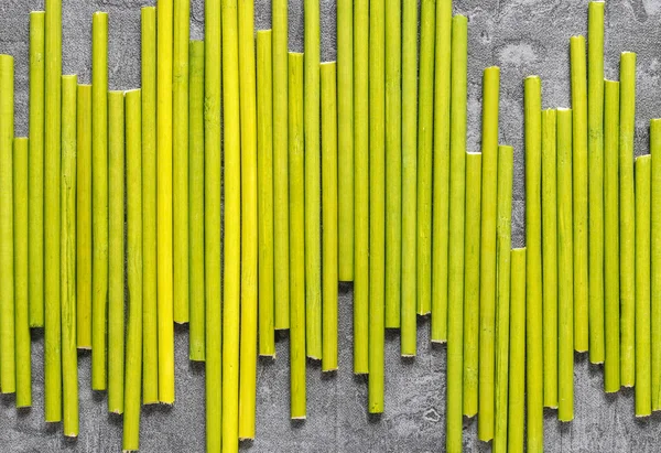 Green sticks on grey background — Stock Photo, Image