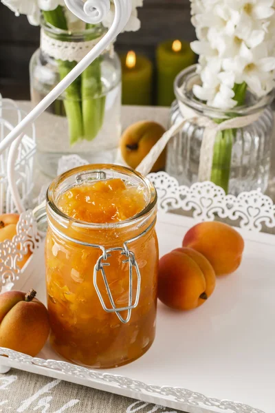 Jar of peach jam and hyacinth flowers in the background — 스톡 사진