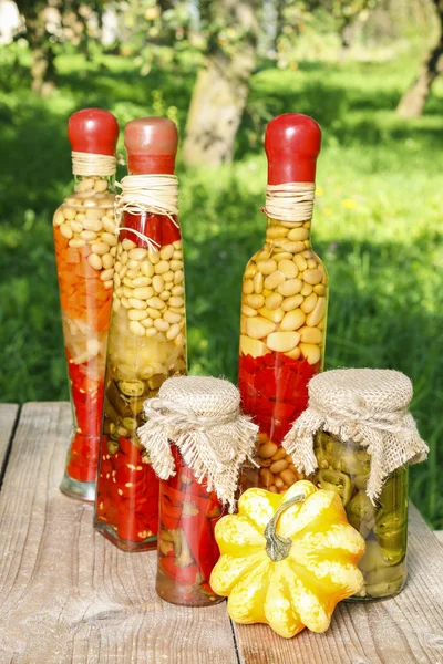 Pumpkins and colorful pickled vegetables in preserving glass — Stock Photo, Image