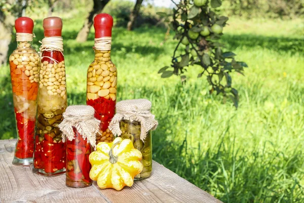 Pumpkins and colorful pickled vegetables in preserving glass — Stock Photo, Image