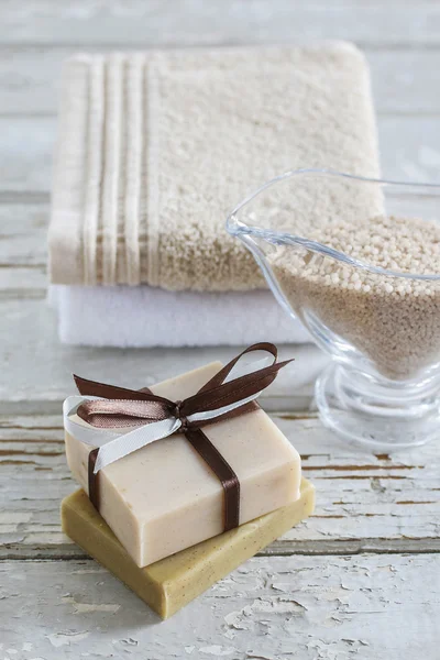 Two bars of handmade soap, sea salt and soft towels on  wood — Stock Photo, Image