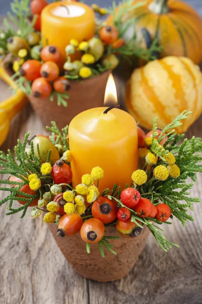 Beautiful table decoration with candle and autumn plants — Stock Photo, Image