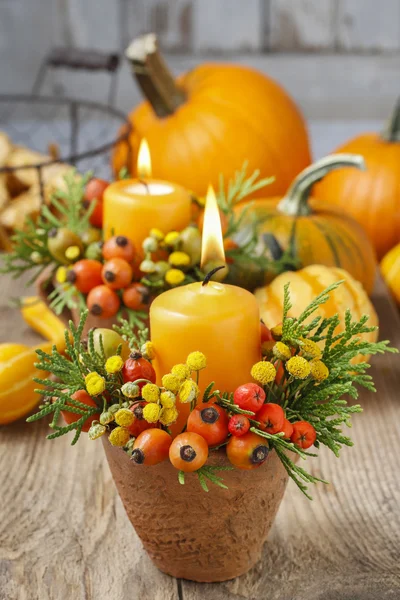 Beautiful table decoration with candle and autumn plants