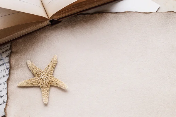 Old sheet of paper, books, letters and a starfish — Stock Photo, Image
