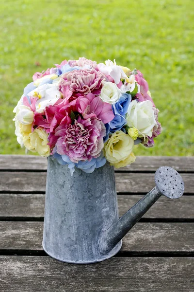 Bouquet of flowers in silver watering can — Stock Photo, Image