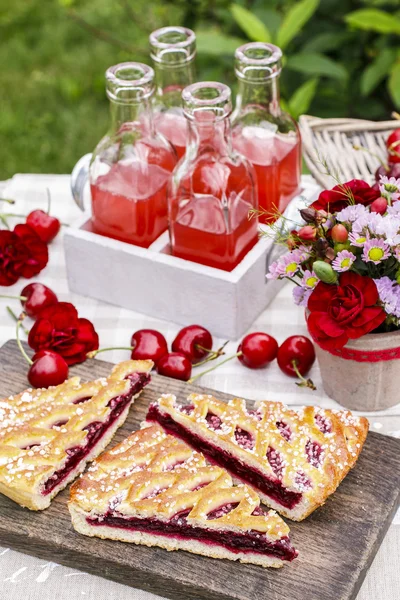 Kirsebærpai og kirsebærsaft. Hagefest – stockfoto