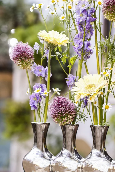 Floral arrangement in modern silver vase — Stock Photo, Image