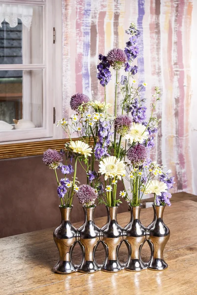 Floral arrangement in modern silver vase — Stock Photo, Image