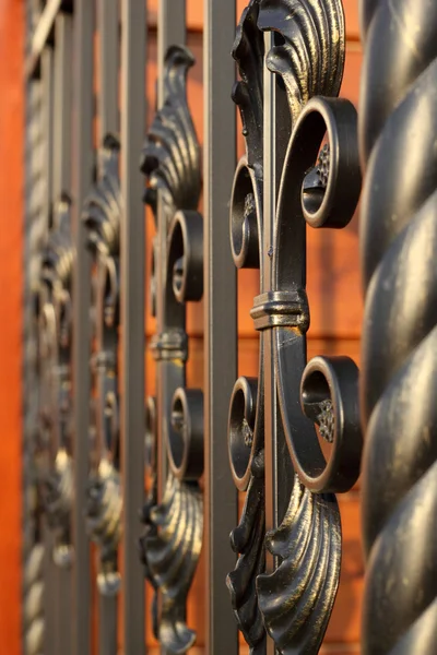 Wrought-iron fence elements partially defocesed in perspective — Stock Photo, Image