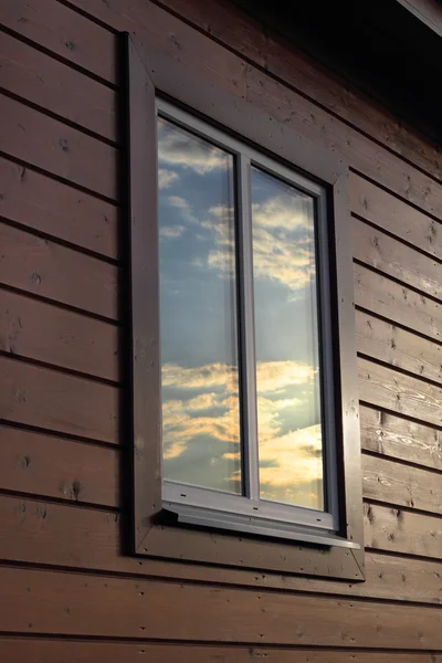 Plastic window in the wooden house wall — Stock Photo, Image