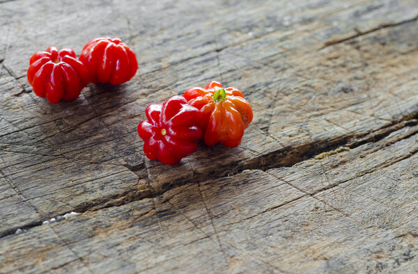 Tropical fruit called Pitanga, Brazilian cherry,Suriname cherry,Cayenne cherry on a woodem backgraund.Shallow depth of field.