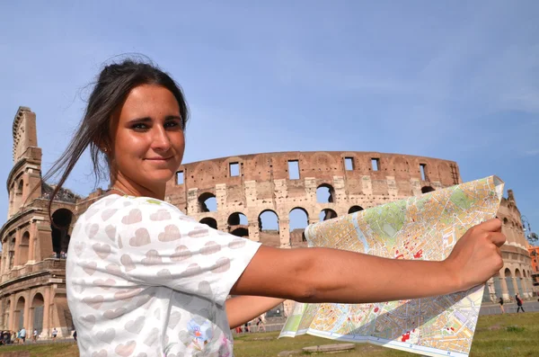 Beautiful attractive brunette tourist girl close to majestic Colosseum in Rome, Italy