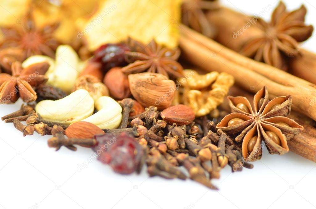 Christmas spices, nuts and dried fruits isolated on white background