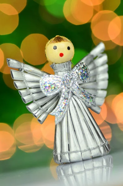 Christmas decoration, silver angel made of straw against bokeh background — Stock Photo, Image