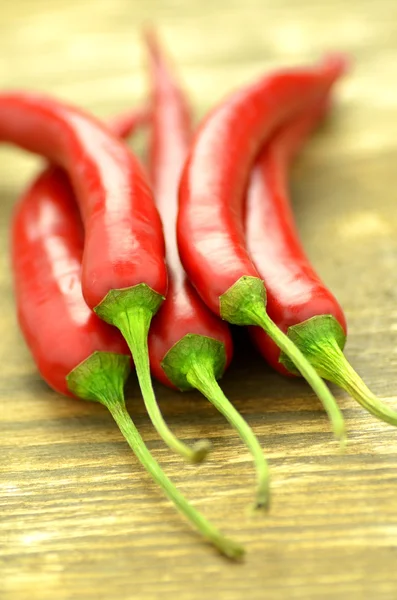 Red hot chilli peppers on table — Stock Photo, Image