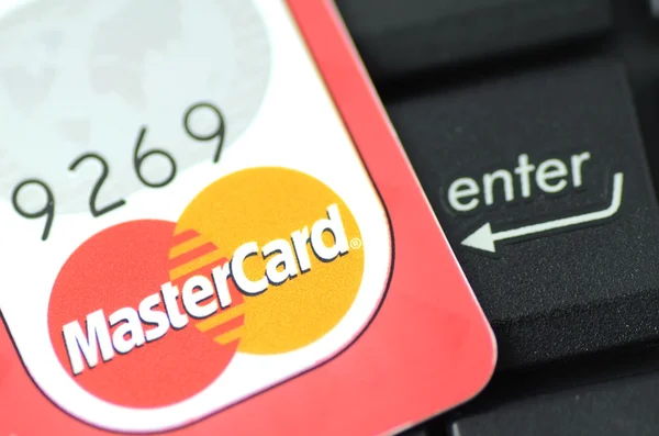 Fechar o cartão de débito MasterCard na tecla enter — Fotografia de Stock