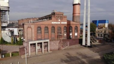 Arial view on Front of brick main building of historical coal mine: Kopalnia Wujek with with the name on wall. Katowice / Poland - 09.2020. 4K, UHD, Cinematic, Aerial footage