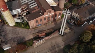 Arial view on Front of brick main building of historical coal mine: Kopalnia Wujek with with the name on wall. Katowice / Poland - 09.2020. 4K, UHD, Cinematic, Aerial footage