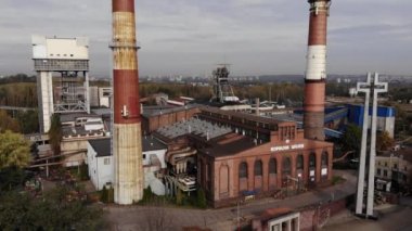 Arial view on Front of brick main building of historical coal mine: Kopalnia Wujek with with the name on wall. Katowice / Poland - 09.2020. 4K, UHD, Cinematic, Aerial footage