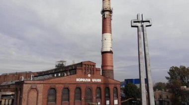 Arial view on Front of brick main building of historical coal mine: Kopalnia Wujek with with the name on wall. Katowice / Poland - 09.2020. 4K, UHD, Cinematic, Aerial footage