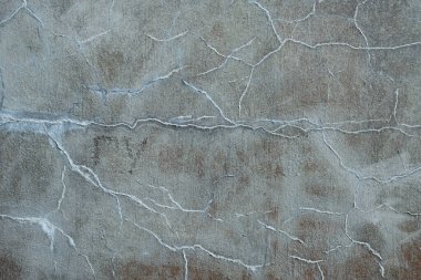 Çatlaklı soyut renkli çimento dokusu ve arkaplanı.