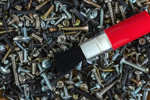 Metal fasteners: screws,self-tapping screws,screws,bolts-scattered on the shop window, with various types of accessories for advertising products.