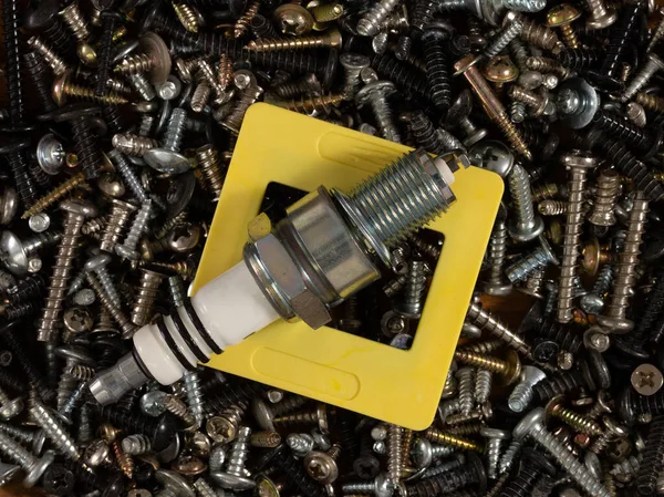 Metal fasteners: screws,self-tapping screws,screws,bolts-scattered on the shop window, with various types of accessories for advertising products.