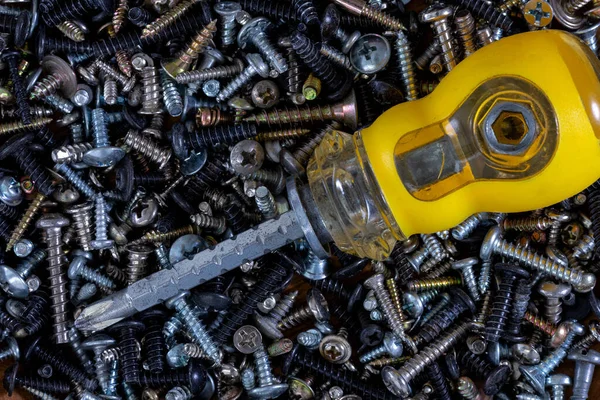 Metal fasteners: screws,self-tapping screws,screws,bolts-scattered on the shop window, with various types of accessories for advertising products.