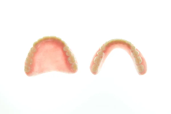 Prótesis dentales sobre fondo blanco — Foto de Stock
