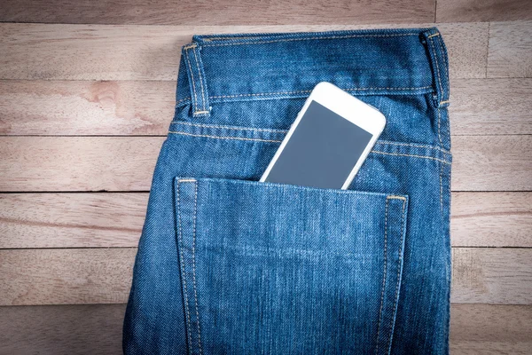 white phone in jeans pocket