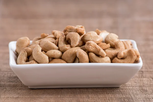 Roasted cashew nuts on wooden background — Stock Photo, Image