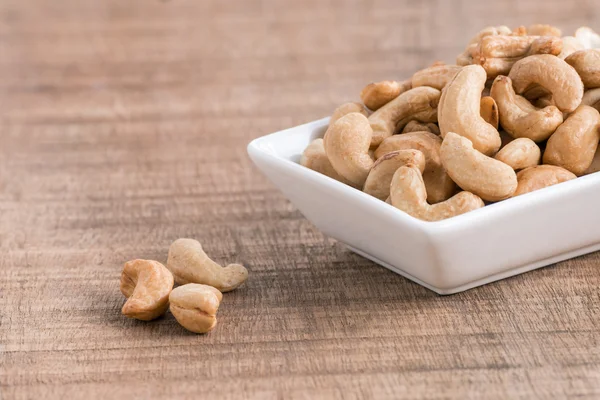 Geroosterde cashewnoten op houten achtergrond — Stockfoto