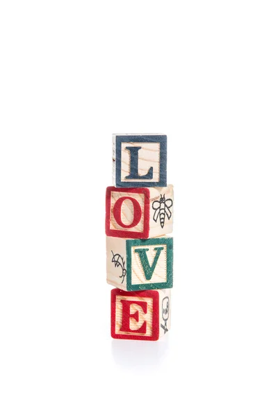 Φωτογραφία από ένα μπλοκ αλφάβητο ορθογραφίας αγάπη απομονωθεί σε λευκό έκφραση — Φωτογραφία Αρχείου
