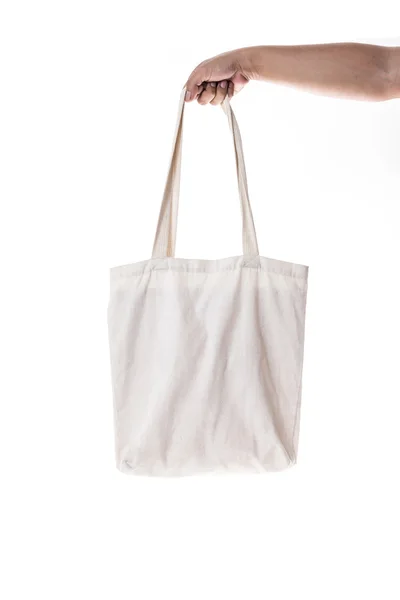 Hand holding cotton eco bag on white background — Stock Photo, Image