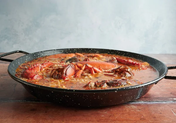 Tahta arka planda ıstakozlu pirinç.