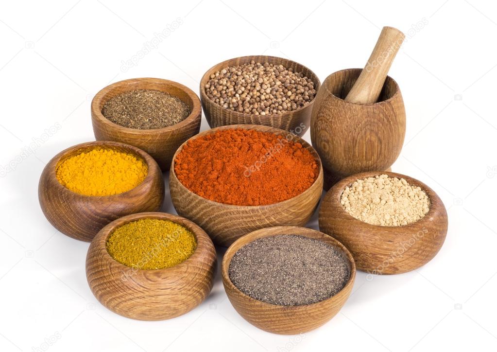 spices and seasoning in wooden bowl on white background