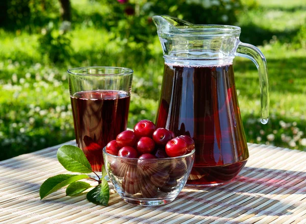 Jugo de cereza en un vaso y una jarra —  Fotos de Stock