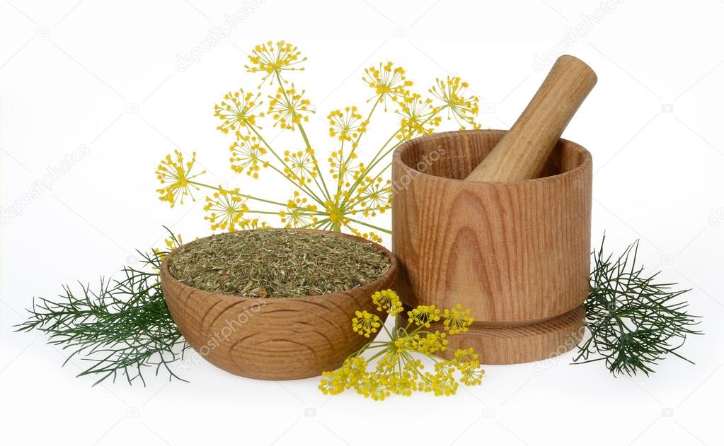 dried dill crushed in a wooden bowl 