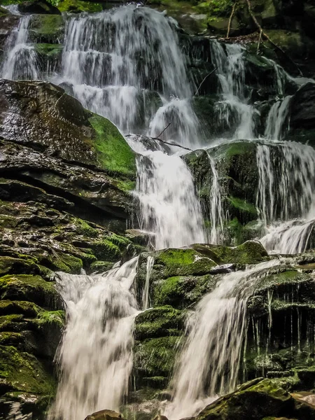 Mountain waterfall, the beautiful waterfall in deep forest in the Carpathians. Ukraine