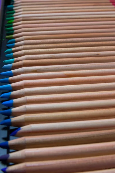 Set of colored pencils in a box. Set of artist\'s pencils. Wooden color pencils. The artist\'s drawing tool. Multi-colored pencils. Pencil point.