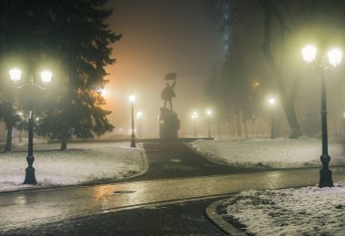Ocak 1918 'deki isyanın siluetinin sisli bir kış parkında sisli bir anıtı. Mariinsky Park 'ta güzel sisli bir akşam. Kyiv, Ukrayna.