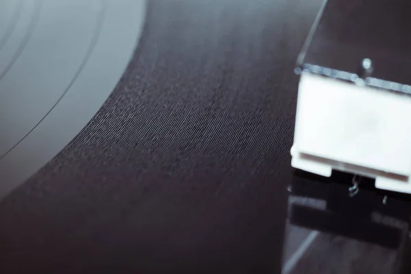Cinemagraph vinyl record spinning. Wide shot close up of needle playing record album on a vintage turntable. Old school record player .retro record vinyl player